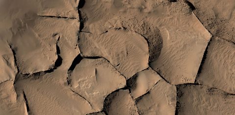 This view from the HiRISE camera on NASA's Mars Reconnaissance Orbiter shows part of an area on Mars where narrow rock ridges, some as tall as a 16-story building, intersect at angles forming corners of polygons. (NASA/JPL-Caltech/Univ. of Arizona)