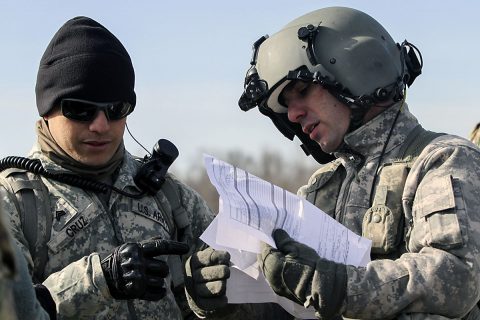 Sgt. Timothy Cruz, left, noncommissioned officer in charge of a sling load training operation for 58th Signal Company, 101st Special Troops Battalion, 101st Airborne Division (Air Assault) Sustainment Brigade, 101st Abn. Div., goes over paperwork with a CH-47 Chinook helicopter pilot from 101st Combat Aviation Brigade, 101st Abn. Div., before the company’s sling load operation Feb. 10, 2017, on Fort Campbell, Kentucky. (Sgt. Neysa Canfield/101st Airborne Division Sustainment Brigade Public Affairs) Sgt. Timothy Cruz, left, noncommissioned officer in charge of a sling load training operation for 58th Signal Company, 101st Special Troops Battalion, 101st Airborne Division (Air Assault) Sustainment Brigade, 101st Abn. Div., goes over paperwork with a CH-47 Chinook helicopter pilot from 101st Combat Aviation Brigade, 101st Abn. Div., before the company’s sling load operation Feb. 10, 2017, on Fort Campbell, Kentucky. (Sgt. Neysa Canfield/101st Airborne Division Sustainment Brigade Public Affairs)