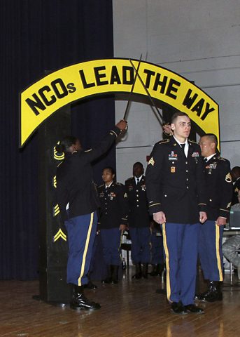 Sgt. Travis Bertovich, an intelligence analyst with 2nd Battalion, 44th Air Defense Artillery Regiment, 101st Airborne Division (Air Assault) Sustainment Brigade, 101st Abn. Div., walks through the golden arches, Feb. 2, 2017, during the brigade’s noncommissioned officer induction ceremony at Wilson Theater, Fort Campbell, Kentucky. The ceremony is a time-honored tradition that welcomes the newly promoted NCOs to the Corps of the Noncommissioned Officer. (U.S. Army photo by Sgt. Neysa Canfield/101st Airborne Division Sustainment Brigade Public Affairs) 