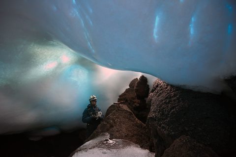 Aaron Curtis, a post-doctoral scholar at JPL, measures gases inside an ice cave. Carbon dioxide levels can be especially high inside the caves, so gas monitors are necessary for safety. (Dylan Taylor)