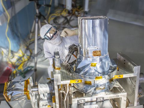 NASA engineer Chip Holloway waits for the sun to align with the Stratospheric Aerosol and Gas Experiment III instrument during a clean room "sun-look" test at NASA's Langley Research Center, Hampton, Virginia. SAGE III will measure aerosols and gases to better understand ozone in Earth's atmosphere. (NASA Langley/Sean Smith)