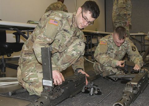 Sgt. Shawn Miller, left, motor transport operator, 2123rd Transportation Company, Kentucky National Guard, assembles a .50-caliber machine gun during a battalion-level master gunner course Feb. 8, 2017, at the Kinnard Mission Training Complex, Fort Campbell, Kentucky. (Sgt. Neysa Canfield/101st Airborne Division Sustainment Brigade Public Affairs) 