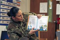 Pfc. Elise M. Fuentes, a military police with 218th Military Police Company, 716th MP Battalion, 101st Airborne Division (Air Assault) Sustainment Brigade, 101st Abn. Div., reads “One Fish, Two Fish, Red Fish, Blue Fish” by Dr. Seuss, March 2, 2017, to the first grade students of Marshall Elementary School on Fort Campbell, Kentucky. (Sgt. Neysa Canfield/101st Airborne Division Sustainment Brigade Public Affairs)