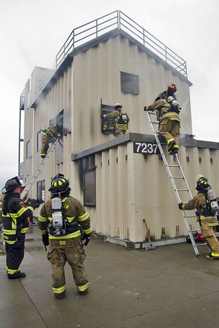 Participants at the second annual Light and Fight regional firefighter training exercise on Fort Campbell demonstrate skills including left hand-right hand search techniques, advancing attack line to seat of fire, using hand tools to open doors, climbing ladder with gear, sounding floor before entry, isolating fire, containing fire, force entry to stairwell then deploy hotel pack from stand pipe and attack fire Feb. 18, 2017, at the Fort Campbell Fire Training Facility. (Leejay Lockhart, Fort Campbell Public Affairs Office)