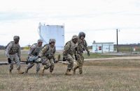 A four-man litter team from the 101st Special Troops Battalion, 101st Airborne Division (Air Assault) Sustainment Brigade, 101st Abn. Div., unloads a simulated patient from an aircraft, March 16, 2017, during medical evacuation training at Hanger 5, Fort Campbell, Kentucky. (Sgt. Neysa Canfield/101st Airborne Division Sustainment Brigade Public Affairs)