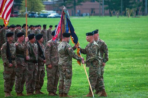 U.S Army Col. Brett Sylvia, commander, 2nd Brigade Combat Team, 101st Airborne Division (Air Assault), right, hands the guidon to Lt. Col. Keith Carter, commander, 1st Battalion, 26th Infantry Regiment, left, during a change of responsibility ceremony, Apr. 18, 2017, at Fort Campbell, Kentucky. Carter is taking over 1-26 from Lt. Col. Ryan Wylie, who led the unit since its activation at Fort Campbell. (U.S Army Photo by 1st Lt. Daniel Johnson) 