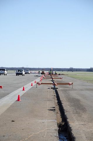 Construction equipment with suction devices that can lift concrete slabs from taxiways at Campbell Army Airfield will speed repairs to CAAF and make them cheaper since it preserves the rock subbase. The repairs are part of a $28 million contract awarded by the Army Corps of Engineers. (Leejay Lockhart, Fort Campbell Public Affairs Office)