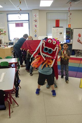 Students in Amanda Tejkowski’s kindergarten class at Barasanti Elementary School huddled under their handmade Chinese dragon in preparation for the school’s fashion show during International Day March 24, 2017. The kindergarten students worked tirelessly designing the dragon using pom poms, styrofoam, glitter and streamers. (Mari-Alice Jasper, Fort Campbell Public Affairs Office)