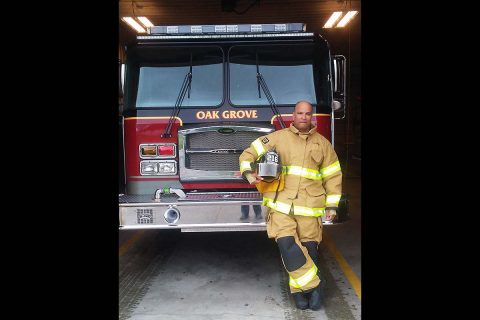 Sergeant 1st Class Julio Mella, 21st Brigade Engineer Battalion, 3rd Brigade Combat Team, 101st Airborne Division poses in front of a firetruck at the Oak Grove Fire Department. Mella has been volunteering as a firefighter and EMT with the department since 2008 and decided he wanted a picture in his full gear before he deployed in November 2016. (Fort Campbell Public Affairs Office)