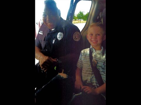 Clarksville Police Officer Evon Parkes with 8 Year Old Quintin Fisher.