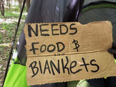 Sign the panhanders were seen carrying.