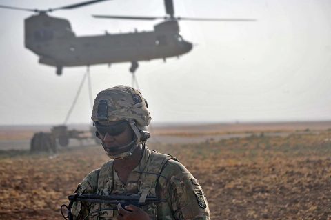 U.S. Army Staff Sgt. Darryl Joseph, a gunnery sergeant with Battery C, 1st Battalion, 320th Field Artillery Regiment, Task Force Strike, communicates with a CH-47 Chinook helicopter crew assigned to the 224th Aviation Regiment, 29th Infantry Division, in Erbil Iraq, Aug. 12, 2016. (1st Lt. Daniel Johnson, 2nd Brigade Combat Team, 101st Airborne Division)