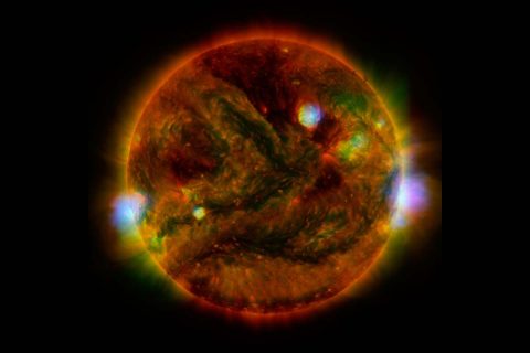 Flaring, active regions of our sun are highlighted in this image combining observations from several telescopes. (NASA/JPL-Caltech/SAO/NOAO)