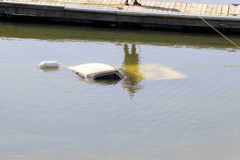 1983 Dodge Pickup being pulled out of the water at Liberty Park's Freedom Point.