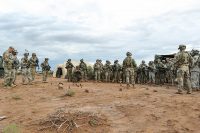 Soldiers with 1st Battalion, 320th Field Artillery Regiment, 2nd Brigade Combat Team, 101st Airborne Division, conduct a three-dimensional map briefing prior to a command post movement, July 23, McGregor Range Complex, New Mexico. Observer controllers oversee activities during Network Integration Evaluation. (Sgt. Maricris C. McLane)