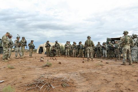 Soldiers with 1st Battalion, 320th Field Artillery Regiment, 2nd Brigade Combat Team, 101st Airborne Division, conduct a three-dimensional map briefing prior to a command post movement, July 23, McGregor Range Complex, New Mexico. Observer controllers oversee activities during Network Integration Evaluation. (Sgt. Maricris C. McLane) 