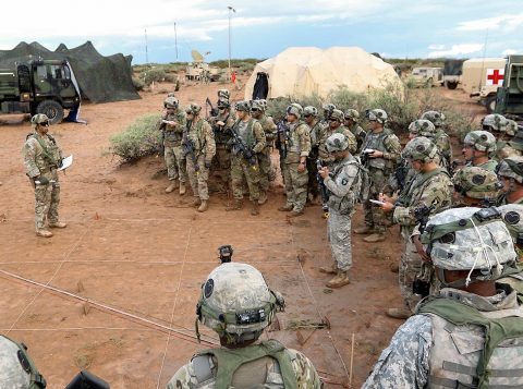 Soldiers with 1st Battalion, 320th Field Artillery Regiment, 2nd Brigade Combat Team, 101st Airborne Division, conduct a sand table convoy briefing prior movement, July 23, McGregor Range Complex, New Mexico. They are training and testing new systems in support of the Network Integration Evaluation 17.2. (Sgt. Thomas Calvert) 