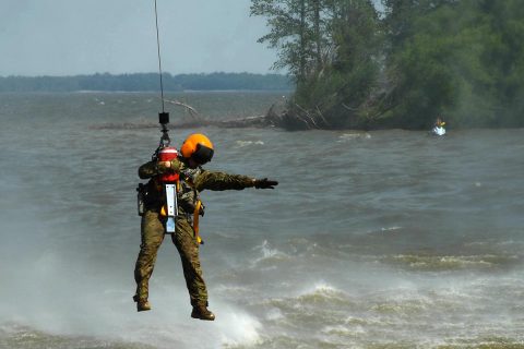 Sgt. Blake Armstrong, a flight medic with Company C, 6th Battalion, 101st Aviation Regiment, 101st Combat Aviation Brigade, uses a hoist June 29, 2017 near Scott Air force Base during over-water training. The training was used to simulate rescuing someone from a life raft while stranded in open water. (Sgt. Marcus Floyd, 101st Combat Aviation Brigade) 