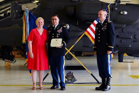 Chief Warrant Officer 4 James Morrow, a flight instructor from Fort Rucker, and wife celebrate his retirement along with Col. Bernard Harrington, the commander of the 82nd Combat Aviation Brigade June 30, 2017 at Fort Campbell, KY. (Sgt. Marcus Floyd, 101st Combat Aviation Brigade) 