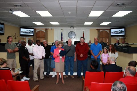 Clarksville Mayor Kim McMillan reads the proclamation honoring Screaming Eagle Ready Mix drivers for shielding mourners at a Fort Campbell memorial service from an out-of-town protest group.