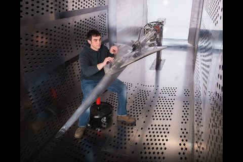 A NASA Glenn technician prepares the QueSST experimental aircraft for testing in the 8’ x 6’ wind tunnel. (NASA)