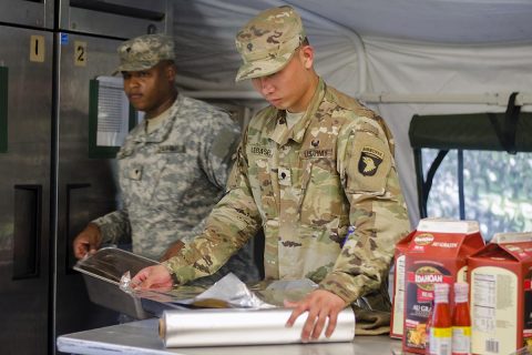 Specialist Johnsid Legaspi, a food service specialist assigned to E Company, 6th Battalion, 101st General Support Aviation Battalion, 101st Combat Aviation Brigade, 101st Airborne Division, helps prepare a lunch featuring fried chicken Aug. 9 at Fort Campbell, Kentucky. Legaspi is part of a 13-member team participating in the Army’s premier culinary arts competition, the Philip A. Connelly Program. (Leejay Lockhart, Fort Campbell Public Affairs Office)