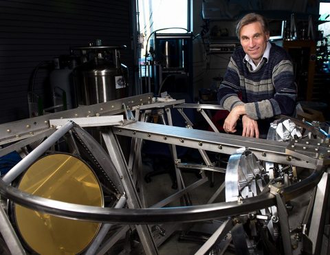 Al Kogut, an astrophysicist at NASA Goddard, poses with one of the millimeter-wave telescopes for the Primordial Inflation Polarization Explorer (PIPER) balloon mission. (NASA's Goddard Space Flight Center/Bill Hryby)