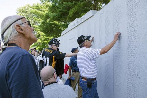 Veterans and their Families who returned to Fort Campbell Sept. 8, 2017, to commemorate the 50th anniversary of the founding of D Company, 3rd Battalion, 187th Infantry Regiment, 3rd Brigade, 101st Airborne Division, visits a wall that includes the names of the Rakkasans that fell in combat during a search and destroy mission in March 1968. These veterans did not find out the fate of the Soldiers evacuated from the battlefield with critical wounds for decades, and the reunion was the first time some of the veterans had seen each other since Vietnam. (Leejay Lockhart)