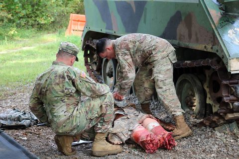 BACH NCO Staff Sgt. Joseph Brown provides feedback to MEDCOM Best Warrior NCO Sgt. 1st Class Christopher Taylor after running a drill at the Alfred V. Rascon School of Combat Medicine, Medical Simulation Training Center on Fort Campbell Sept. 19. (U.S. Army Photo by Maria Yager)