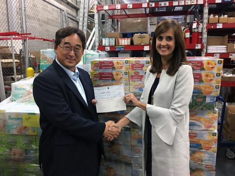 Jay Kim, Vice President of Corporate Strategy for Hankook Tire America Corp. hands Ginna Holleman, CEO of Clarksville United Way a check for $10,000 to be used for towards supplies for the victims of Hurricane Harvey.