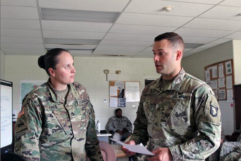 Staff Sgt. Cole Champion (right), a motor transport operator assigned to the 1176th Transportation Company of the Tennessee National Guard, assigned to the 101st Airborne Division Sustainment Brigade, 101st Abn. Div., speaks to Staff Sgt. Lisa Evans, assigned to the 541st Transportation Company, 129th Combat Sustainment Support Battalion, 101st Abn. Div. Sust. Bde, about upcoming missions in the company on Fort Campbell, Kentucky. (Sgt. Neysa Canfield, 101st Sustainment Brigade, 101st Airborne Division (AA) Public Affairs)