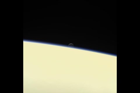 Saturn's active, ocean-bearing moon Enceladus sinks behind the giant planet in a farewell portrait from NASA's Cassini spacecraft. This view of Enceladus was taken by NASA's Cassini spacecraft on Sept. 13, 2017. It is among the last images Cassini sent back. (NASA/JPL-Caltech/Space Science Institute)