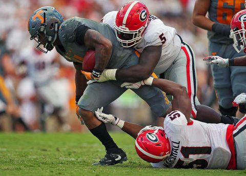 Tennessee Volunteers running back John Kelly (4) is tackled by Georgia Bulldogs defensive lineman Julian Rochester (5) and linebacker David Marshall (51) during the second half at Neyland Stadium. (Crystal LoGiudice-USA TODAY Sports)