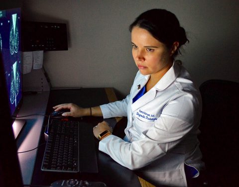 Blanchfield Army Community Hospital Chief of Mammography and Ultrasound, Maj. Sara Michael, a diagnostic radiologist, reviews a mammogram Oct. 11 to look for any abnormalities in the breast tissue that could require further testing. Women over age 40 should have a mammogram annually to detect for signs of breast cancer. Women over age 40 who receive care at BACH can call the mammography clinic directly to schedule their annual mammogram. (Maria Yager)