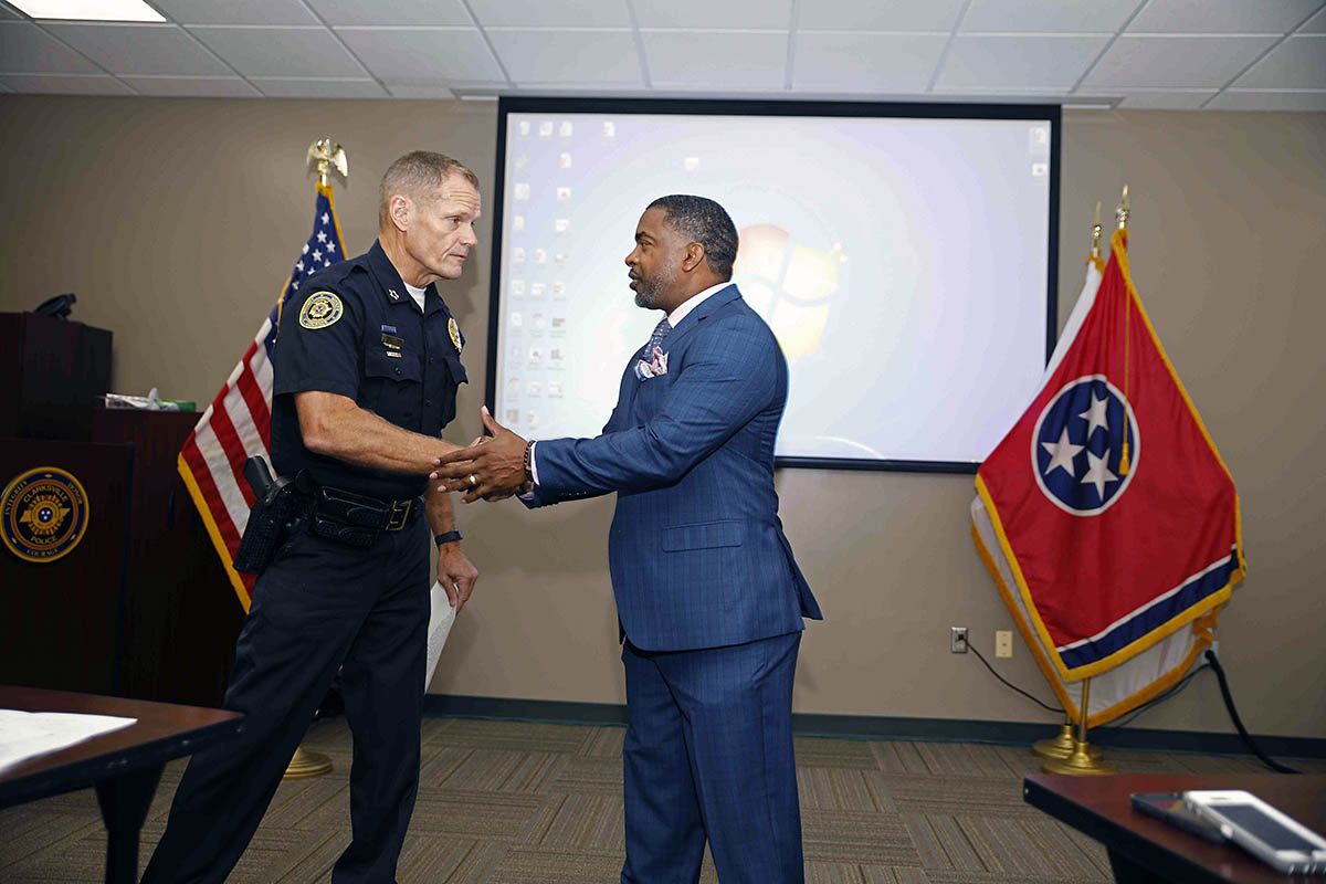 Clarksville Police Chief Al Ansley presents Willie Austin with a Citizen Commendation Friday.