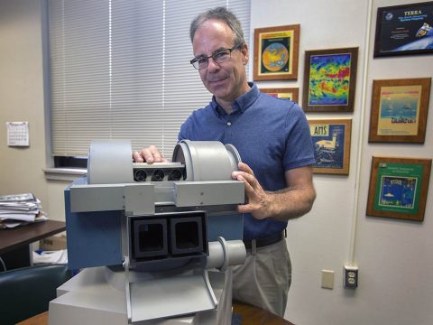 Norman Loeb, principal investigator of NASA’s Radiaton Budget Science Project, is pictured with a CERES model, which studies the clouds and monitor Earth's “energy budget.” (NASA/David C. Bowman)