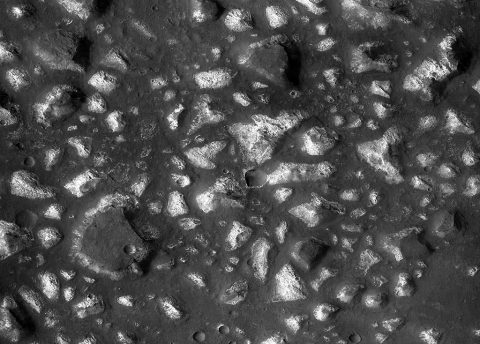This view of a portion of the Eridania region of Mars shows blocks of deep-basin deposits that have been surrounded and partially buried by younger volcanic deposits. (NASA/JPL-Caltech/MSSS) This view of a portion of the Eridania region of Mars shows blocks of deep-basin deposits that have been surrounded and partially buried by younger volcanic deposits. (NASA/JPL-Caltech/MSSS)