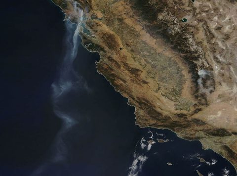 NASA’s Terra satellite saw a stream of smoke that extended over 500 miles from various fires raging in northern California out over the Eastern Pacific Ocean. (NASA image courtesy Jeff Schmaltz, MODIS Rapid Response Team.)