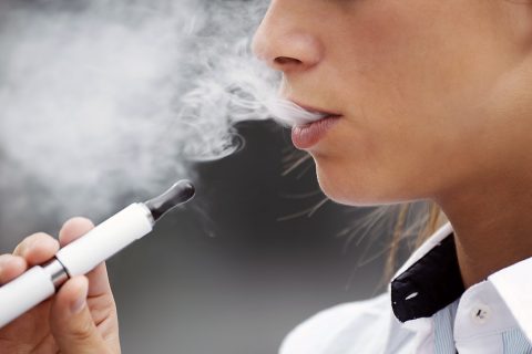 Closeup of woman smoking electronic cigarette outdoor. Proposal to ban menthol cigarettes and flavored cigars is historic and long overdue. (American Heart Association)