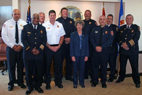 Deputy Fire Chief Ray Williams, second from left, Clarksville Mayor Kim McMillan and Clarksville Fire Chief Mike Roberts, right, joined to congratulate the seven Clarksville Fire Rescue leaders who recently earned promotions. 