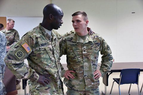 Spc. Ryan McKnight and Spc. Ernest Harlan, both Tennessee National Guard members assigned to Detachment 5, Company B, 248th Aviation Support Battalion, Nashville, Tenn., discuss some of the things they are looking forward to during their deployment to Kuwait at their departure ceremony Sept. 28. The twenty-two Guard members who volunteered for the deployment left Joint Base Berry Field Sept. 30 to participate in predeployment training at Fort Hood, Texas. 