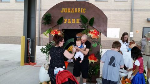 Jenny Phillips, wife of Capt. Michael Phillips, assigned to Headquarters and Headquarters Detachment, 716th Military Police Battalion, 101st Airborne Division (Air Assault) Sustainment Brigade, 101st Abn. Div. stands in front of her Jurassic Park themed vehicle, Oct. 20, 2017, during the battalion’s annual fall festival on Fort Campbell, Kentucky. (1st Lt. Amanda Thomson-Tangalin/716th MP BN UPAR) 