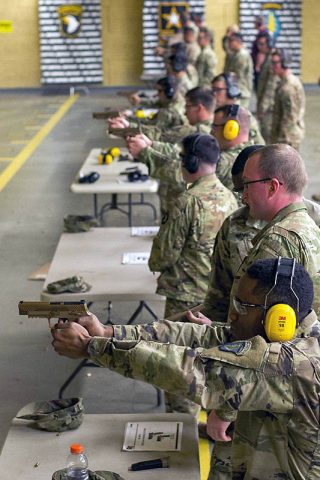 Soldiers with C Company, 1st Battalion, 506th Infantry Regiment, 1st Brigade Combat Team, 101st Airborne Division (Air Assault) fire the new M17 or Modular Handgun System at the 5th Special Forces Group (Airborne) indoor range, November 28th. (Sgt. Samantha Stoffregen, 101st Airborne Division (Air Assault) Public Affairs) 