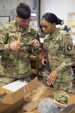 1st Lt. Jon Yerby and Pvt. 1st Class Tia Alexander, C Company, 1st Battalion, 506th Infantry Regiment, 1st Brigade Combat Team, 101st Airborne Division (Air Assault) inspect and inventory an M17 or Modular Handgun System at an installation warehouse, November 27th. (Sgt. Samantha Stoffregen, 101st Airborne Division (Air Assault) Public Affairs) 