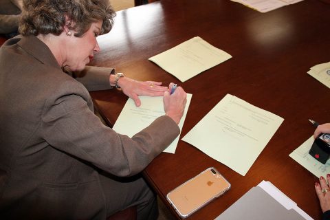 Clarksville Mayor Kim McMillan signs final documents to refund the last of three CDE Lightband bond issues. The refinancing of the bonds will save the utility more than $15 million in bond payments over the next 20 years.