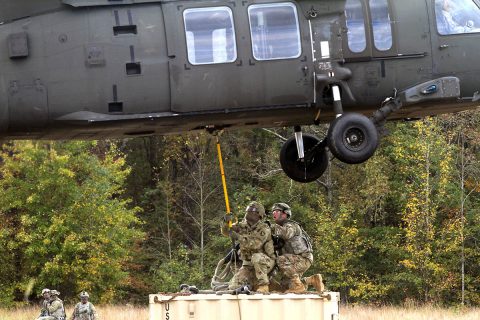 (L to R) Spc. Anthony Addcock and Staff Sgt. Jerry Barnhart from 594th Transportation Company, 129th Combat Sustainment Support Battalion, 101st Airborne Division (Air Assault) Sustainment Brigade, 101st Abn. Div., conduct a sling load operation during 129th CSSB’s field training exercise on Fort Campbell, Kentucky, Oct. 25, 2017. (Pfc. Alexes Anderson/101st Airborne Division Sustainment Brigade) 