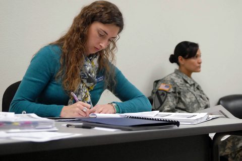 Katie Copeskey, left, a master resilience trainer-performance expert at the Fort Hood Comprehensive Soldier and Family Fitness Training Facility, takes notes during a Resilience Trainer Assistant Course in Killeen, Texas. (Sgt. John Couffer)