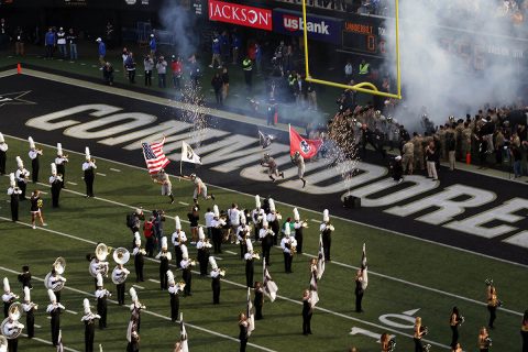 Vanderbilt University football players run through a tunnel of soldiers of the 2nd Battalion, 32nd Field Artillery Regiment, carrying the U.S. flag, a POW/MIA flag, Tennessee state flag, and the 101st Airborne Division “Screaming Eagles” flag before the University of Kentucky vs. Vanderbilt University football game, Nov. 11. The ceremonies were part of Vanderbilt University’s recognition of Veterans Day. (Staff Sgt. Todd Pouliot, 40th Public Affairs Detachment)