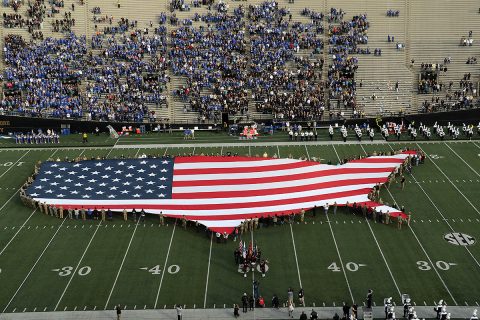 Soldiers of the 2nd Battalion, 32nd Field Artillery Regiment, 101st Airborne Division Artillery, hold the ceremonial replica flag before the University of Kentucky vs. Vanderbilt University football game, Nov. 11. The replica flag was in the shape of the continental United States of America, and was part of Vanderbilt University’s Veterans Day Salute to Service. (Staff Sgt. Todd Pouliot, 40th Public Affairs Detachment)