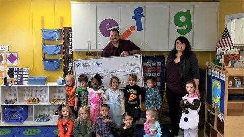 John Bredehoeft (left), project director for Campbell Crossing, presented a check to Karen Grimsley, Executive Director for the Armed Services YMCA at Fort Campbell.